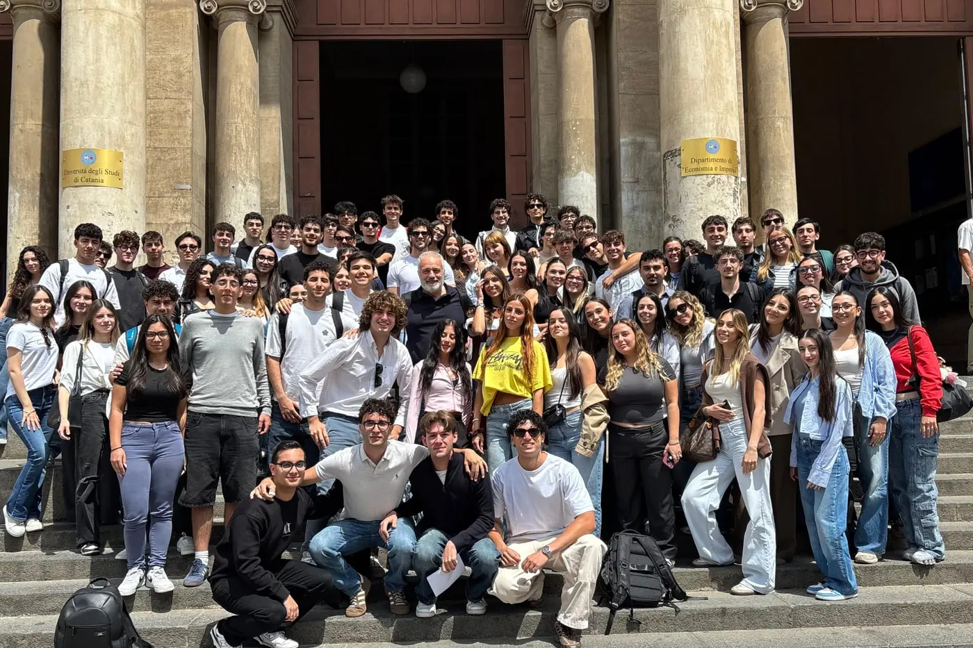 Group photo of students on the steps of the Department of Economics and Business