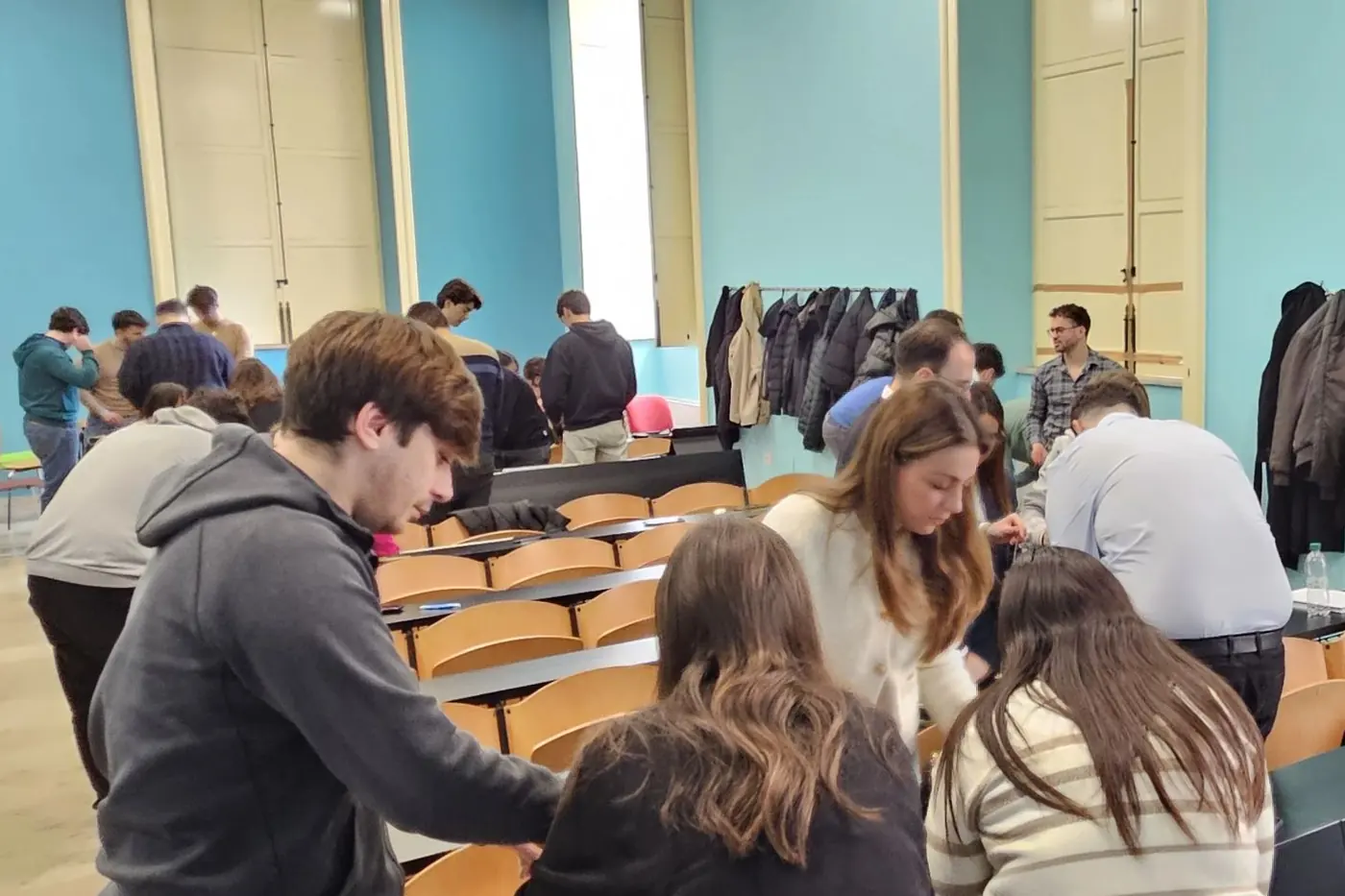Students standing around the desks during group work